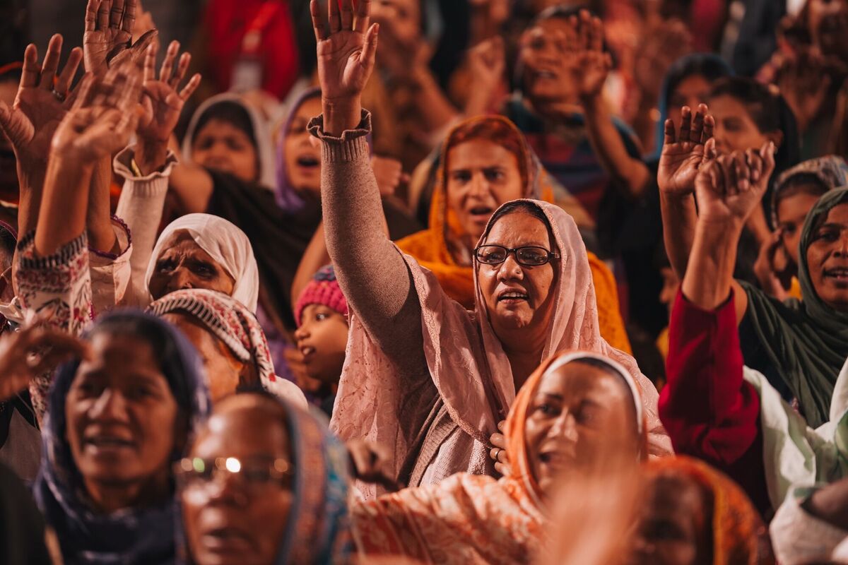 Women lifting their hands in worship at the crusade