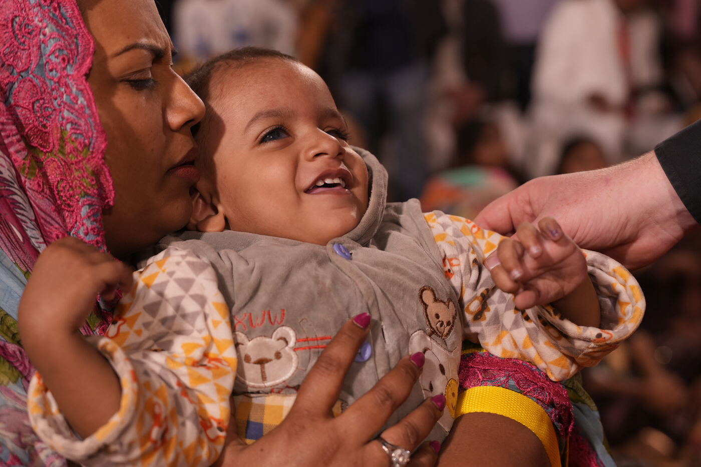 A mother holding her laughing baby