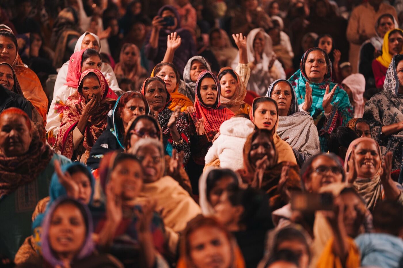 Women clapping and singing at the crusade in Karachi